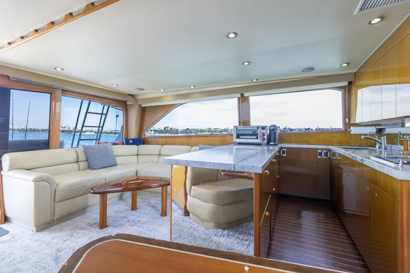 Slide: The Image of Luxurious interior of a 2001 Viking 55 Convertible yacht with modern kitchen and seating area. - 3