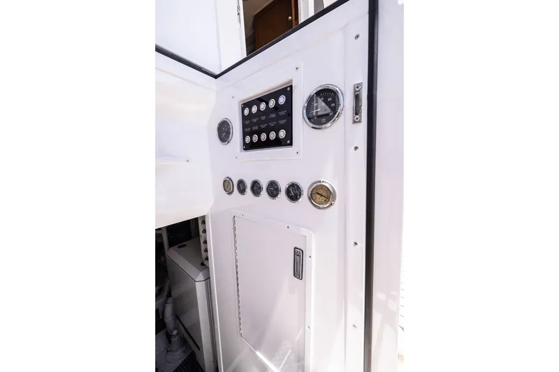 Slide: The Image of Control panel of a 2001 Viking 55 Convertible yacht, featuring gauges and switches. - 19