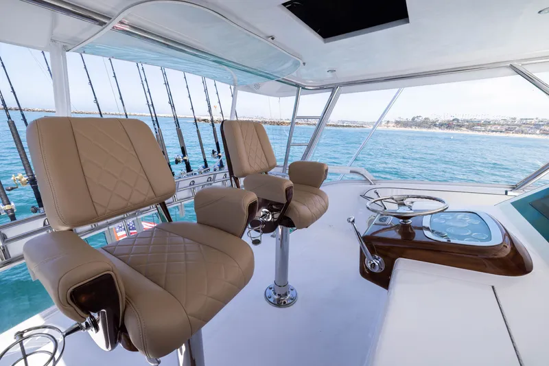 Slide: The Image of Luxurious helm of 2001 Viking 55 Convertible yacht with leather seats and ocean view. - 11