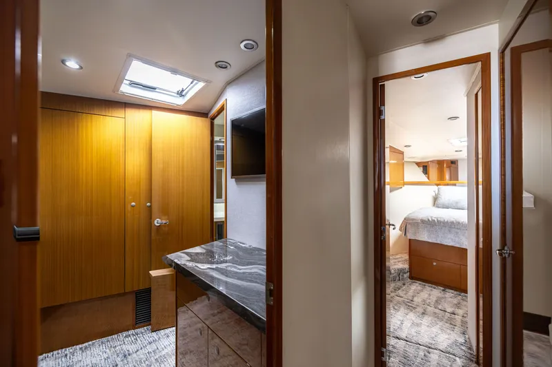 Slide: The Image of Interior of 2001 Viking 55 Convertible yacht, featuring wood cabinetry and a cozy bedroom. - 45