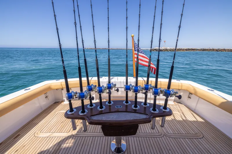 Slide: The Image of 2001 Viking 55 Convertible yacht with fishing rods and American flag on deck. - 8