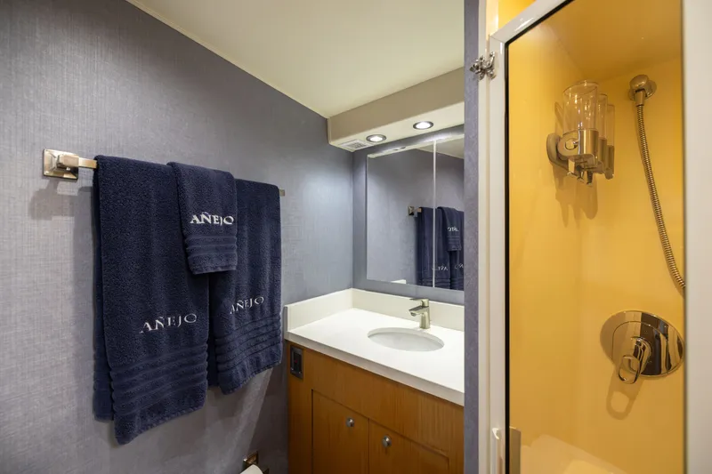 Slide: The Image of Bathroom interior of 2001 Viking 55 Convertible yacht with towels and shower. - 43