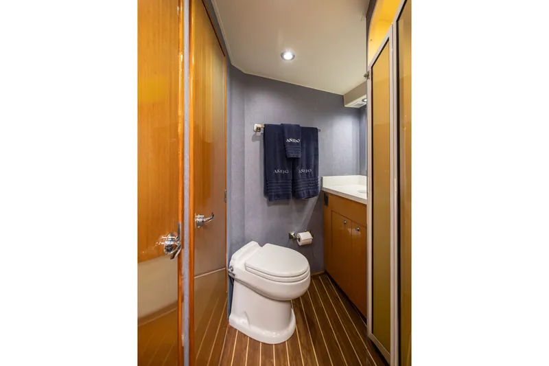 Slide: The Image of Bathroom interior of 2001 Viking 55 Convertible yacht with modern fixtures and wood accents. - 59