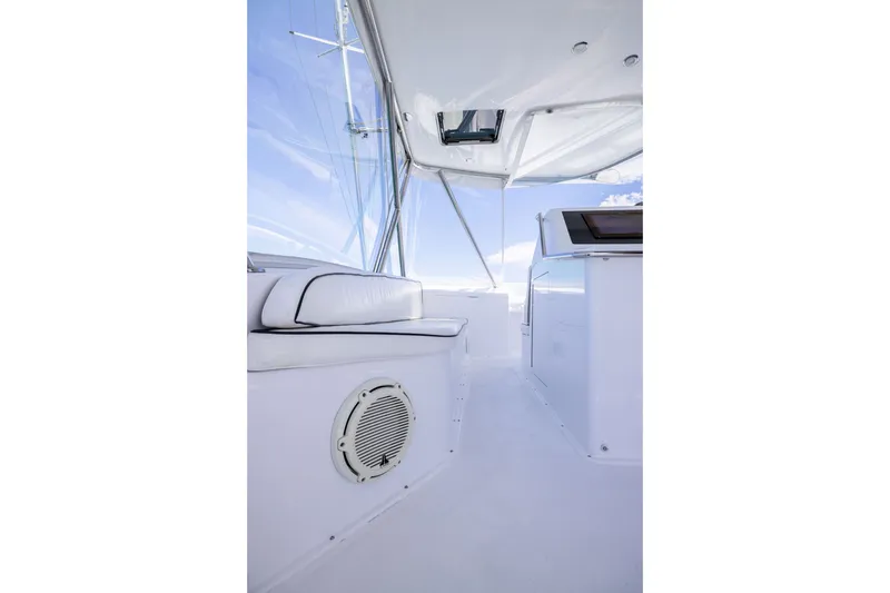 Slide: The Image of Interior view of 2001 Viking 55 Convertible yacht, featuring sleek white seating and modern design. - 23