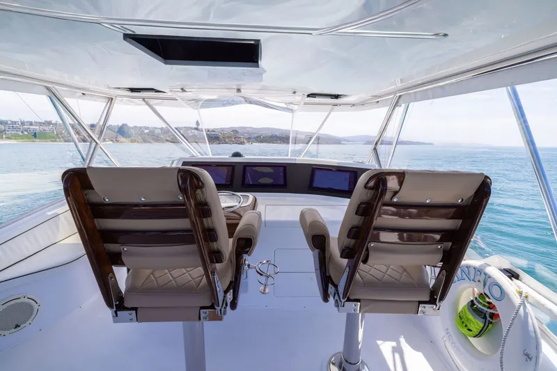Slide: The Image of Helm of 2001 Viking 55 Convertible yacht with dual captain chairs and ocean view. - 12