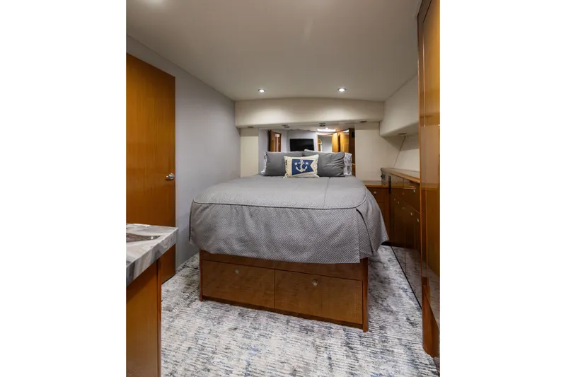 Slide: The Image of Luxurious bedroom interior of 2001 Viking 55 Convertible yacht with elegant wood finishes. - 39