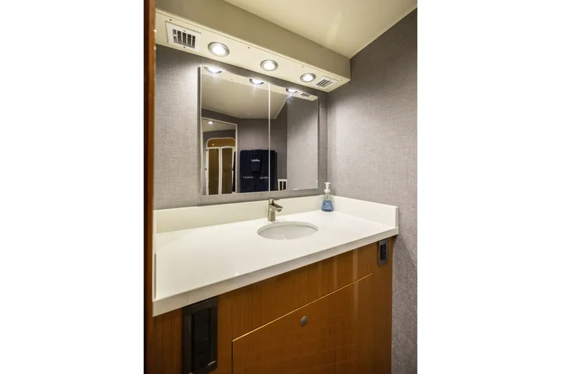 Slide: The Image of Luxurious bathroom vanity in 2001 Viking 55 Convertible yacht, featuring modern fixtures and lighting. - 49