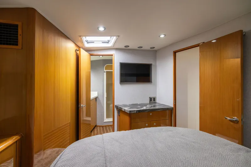 Slide: The Image of Interior of 2001 Viking 55 Convertible yacht cabin with wood paneling and modern amenities. - 42