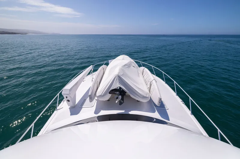 Slide: The Image of Bow view of 2001 Viking 55 Convertible yacht cruising on open sea. - 27