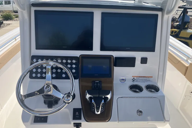 Slide: The Image of 2027 Caymas 291 boat dashboard with dual screens and modern controls. - 19