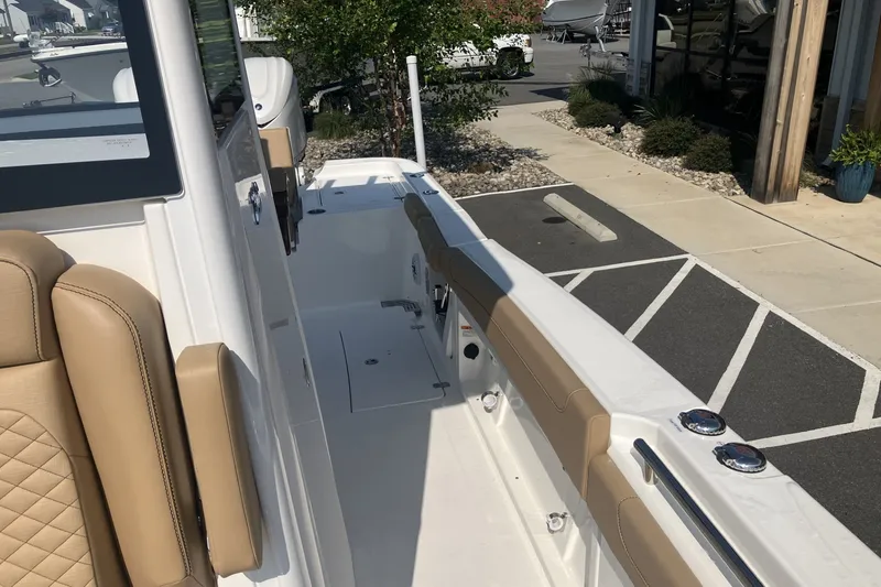 Slide: The Image of 2027 Caymas 291 boat with tan seating and sleek white deck design. - 12
