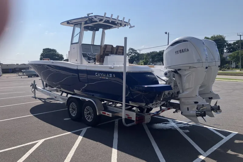 Slide: The Image of 2027 Caymas 291 boat with dual Yamaha engines on a trailer in a parking lot. - 5