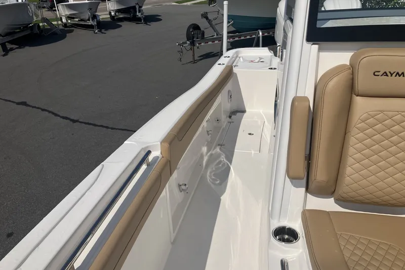 Slide: The Image of 2027 Caymas 291 boat interior with tan seating and sleek design. - 13