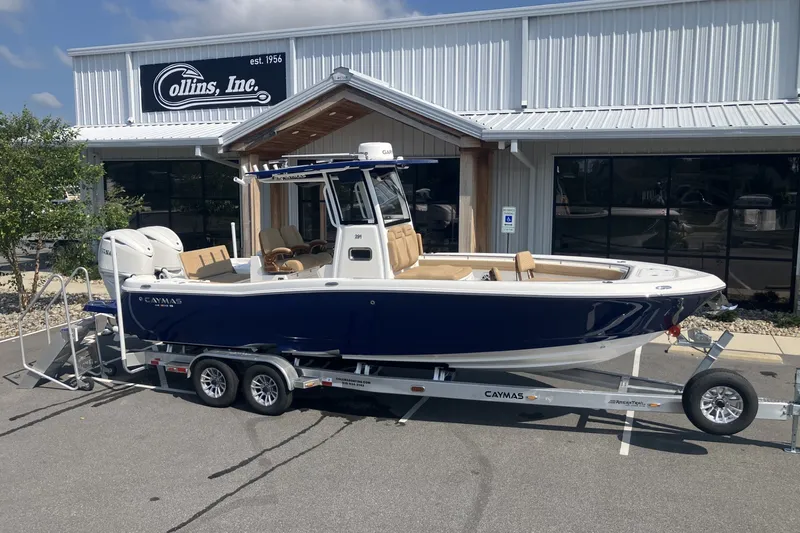 The Image of 2027 Caymas 291 boat on trailer outside Collins Inc. dealership. - 1