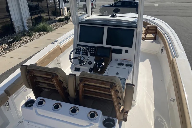 Slide: The Image of 2027 Caymas 291 boat interior with dual screens and steering wheel. - 21