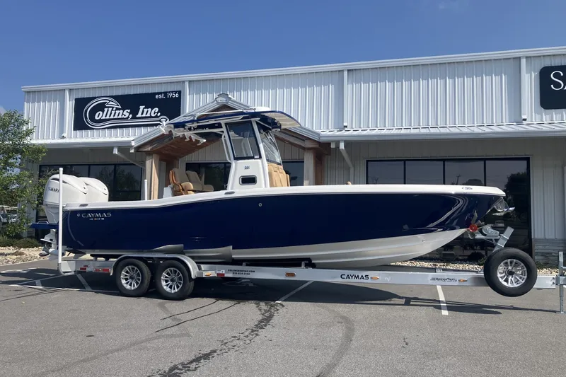 Slide: The Image of 2027 Caymas 291 boat on trailer outside Collins Inc. dealership. - 2
