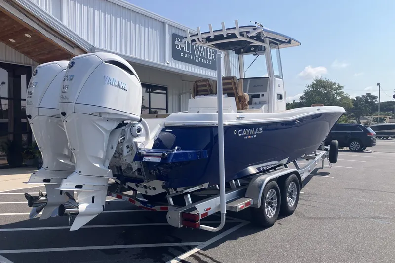 Slide: The Image of 2027 Caymas 291 boat with dual Yamaha engines on a trailer outside Saltwater Outfitters. - 3