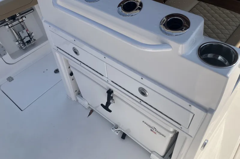 Slide: The Image of 2027 Caymas 291 boat interior with storage compartments and cup holders. - 15