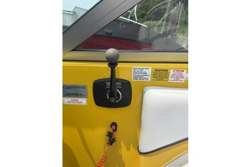 Slide: The Image of Yellow interior of 2009 Gekko Revo boat with control lever and safety labels. - 6