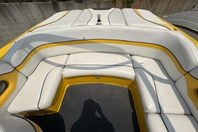 Slide: The Image of 2009 Gekko Revo boat interior with yellow and white cushioned seating. - 7