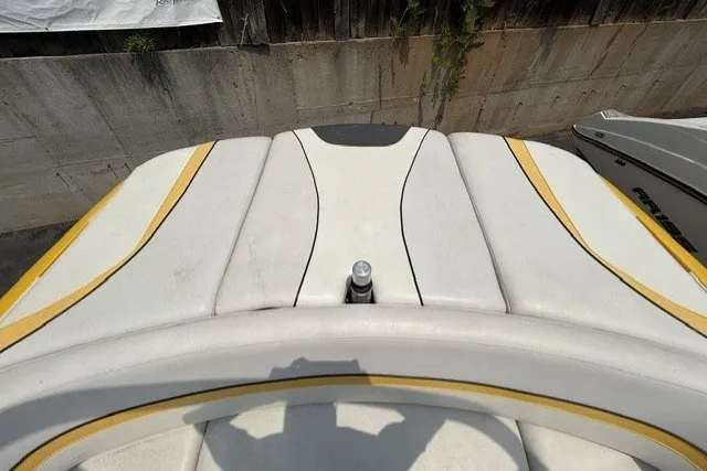 Slide: The Image of Rear view of a 2009 Gekko Revo boat with white and yellow upholstery. - 8