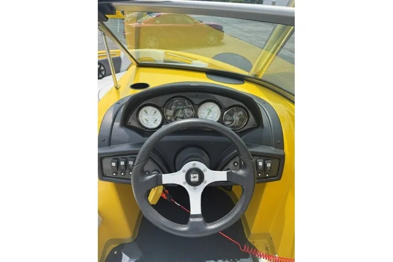 Slide: The Image of Steering wheel and dashboard of a 2009 Gekko Revo boat, featuring gauges and controls. - 5