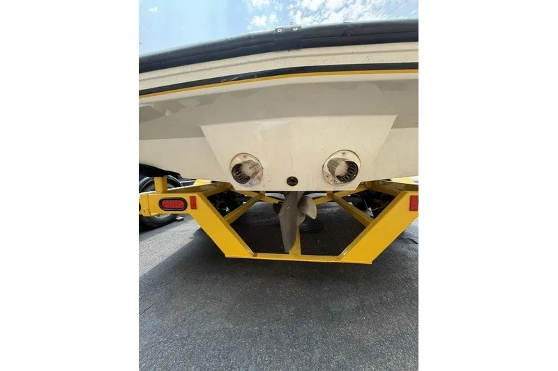 Slide: The Image of Rear view of 2009 Gekko Revo boat on yellow trailer, showing propeller and exhaust. - 4