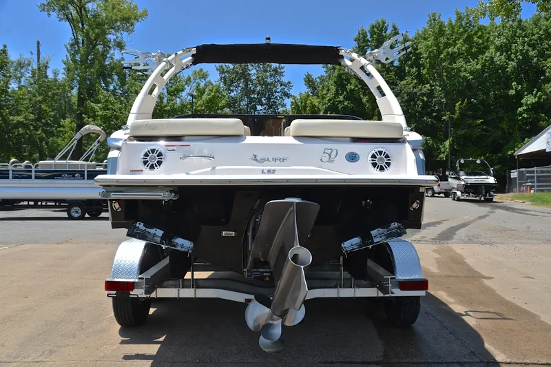 Slide: The Image of 2020 Regal LS2 Surf boat on trailer, rear view, outdoors. - 14
