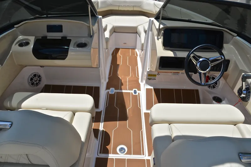 Slide: The Image of Interior of a 2020 Regal LS2 Surf boat with beige seating and wood-style flooring. - 26