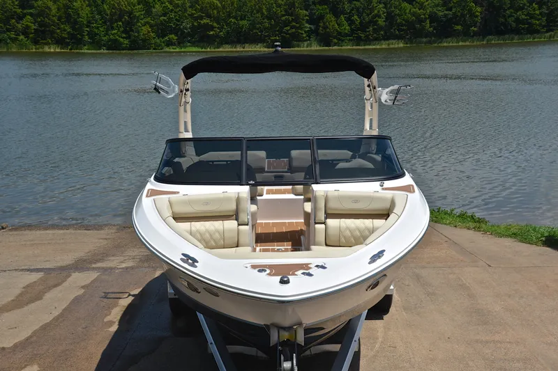 Slide: The Image of 2020 Regal LS2 Surf boat on trailer by a scenic lake. - 18