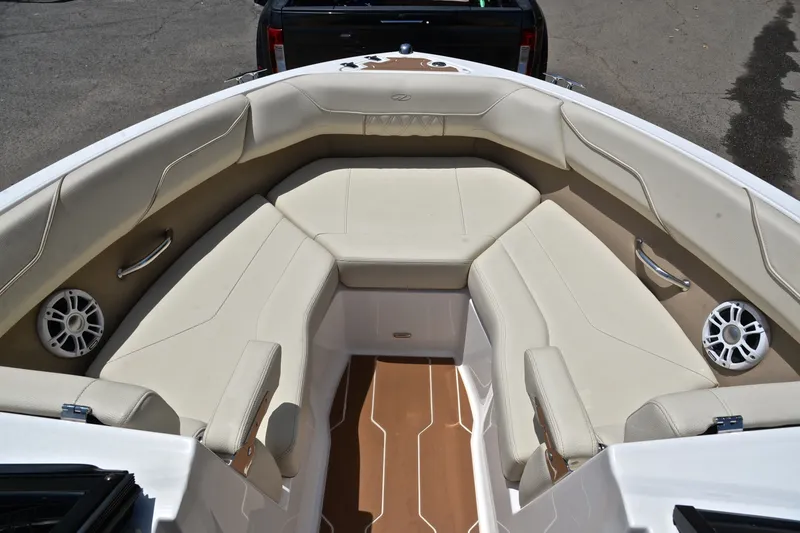 Slide: The Image of 2020 Regal LS2 Surf boat interior with beige seating and speakers. - 22