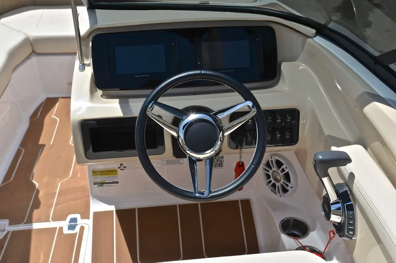 Slide: The Image of 2020 Regal LS2 Surf boat dashboard with steering wheel and control panel. - 27