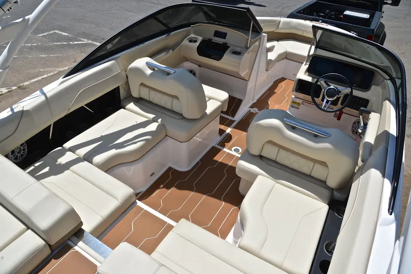 Slide: The Image of Luxurious interior of 2020 Regal LS2 Surf boat with beige seating and modern dashboard. - 20