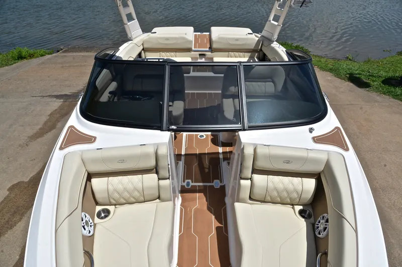 Slide: The Image of 2020 Regal LS2 Surf boat with luxurious seating and sleek design by the water. - 21