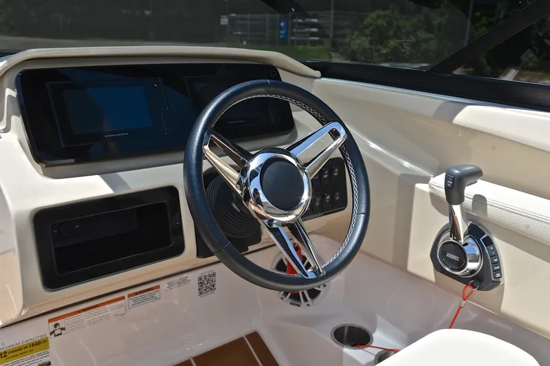 Slide: The Image of 2020 Regal LS2 Surf boat dashboard with steering wheel and controls. - 28