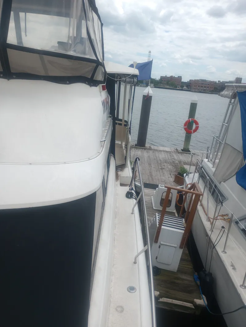 Slide: The Image of 1991 Silverton AFT CABIN docked with a view of the water. - 9