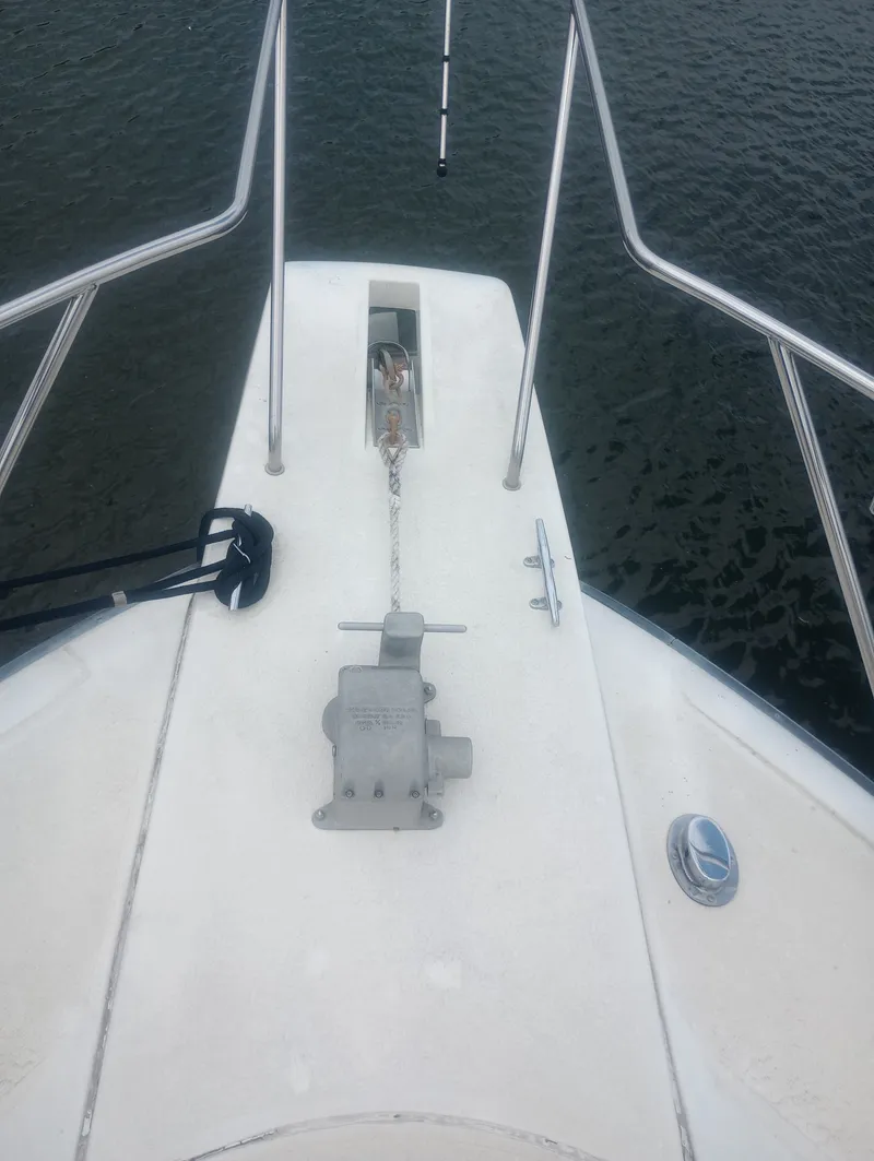 Slide: The Image of The image shows the bow deck of a 1991 Silverton AFT CABIN with an anchor winch. - 6
