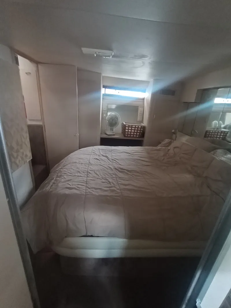 Slide: The Image of Bedroom in a 1991 Silverton AFT CABIN with a large bed and windows. - 37