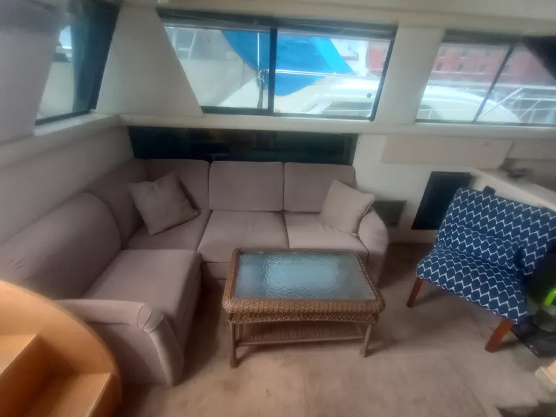 Slide: The Image of The image shows the interior of a 1991 Silverton AFT CABIN with a cozy sofa and glass table. - 21