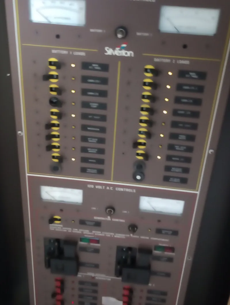 Slide: The Image of An electrical control panel on a 1991 Silverton AFT CABIN boat with various switches and gauges. - 38