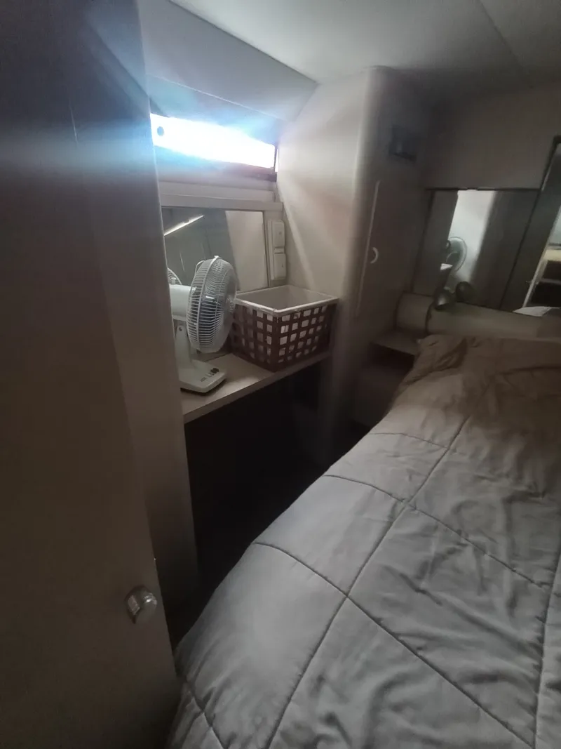 Slide: The Image of Interior of a 1991 Silverton AFT CABIN with bed and window. - 33
