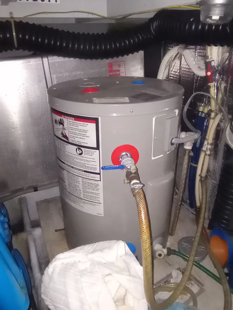 Slide: The Image of A water heater in an engine room with hoses and pipes. - 45
