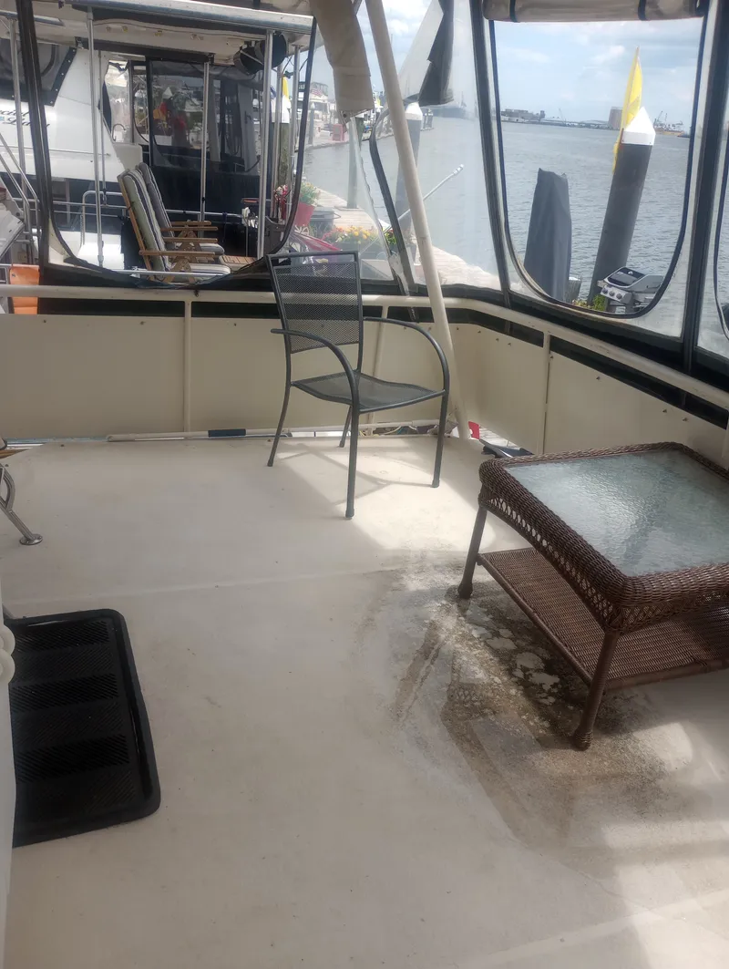 Slide: The Image of The image shows the aft deck of a 1991 Silverton AFT CABIN with chairs and a table. - 13