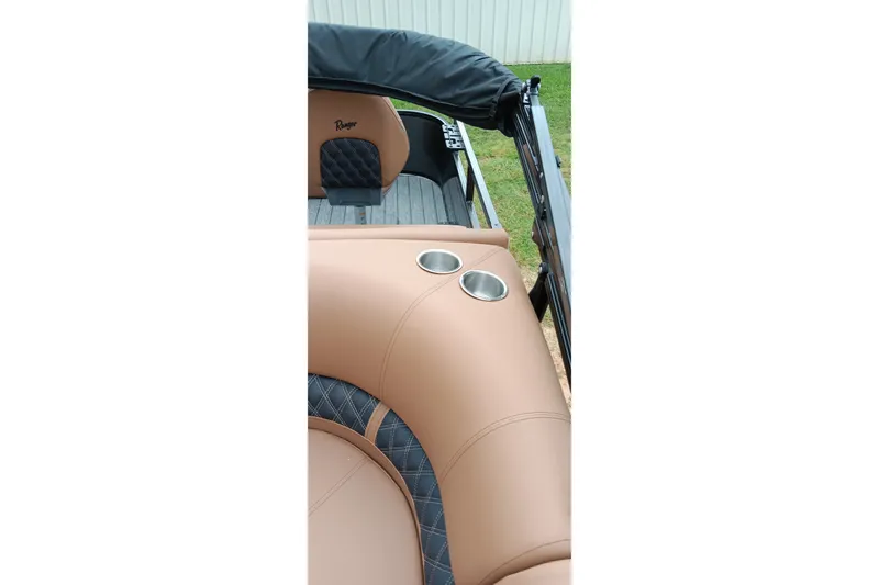 Slide: The Image of 2026 Ranger 220F boat interior with tan leather seating and cup holders. - 30