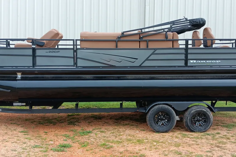Slide: The Image of 2026 Ranger 220F pontoon boat on trailer, featuring sleek design and comfortable seating. - 1