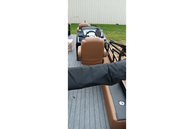 Slide: The Image of 2026 Ranger 220F boat interior with brown seats and steering console. - 10