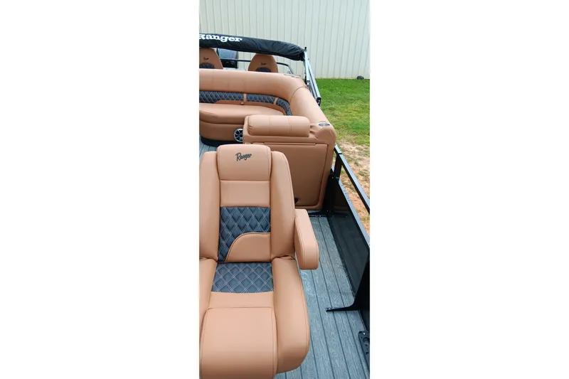 Slide: The Image of 2026 Ranger 220F boat interior with tan and gray seating, showcasing luxury and comfort. - 26