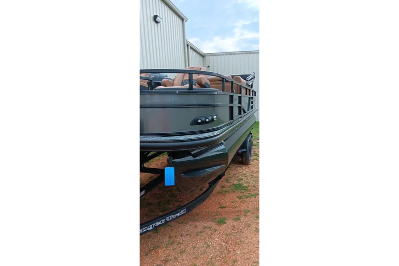 Slide: The Image of 2026 Ranger 220F boat parked outside a metal building on a trailer. - 23