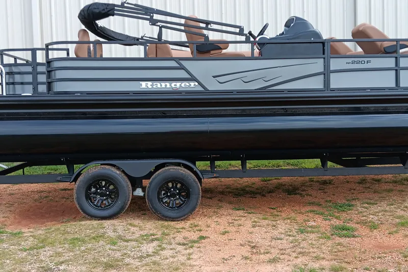 The Image of 2026 Ranger 220F pontoon boat on trailer, side view, outdoors. - 0