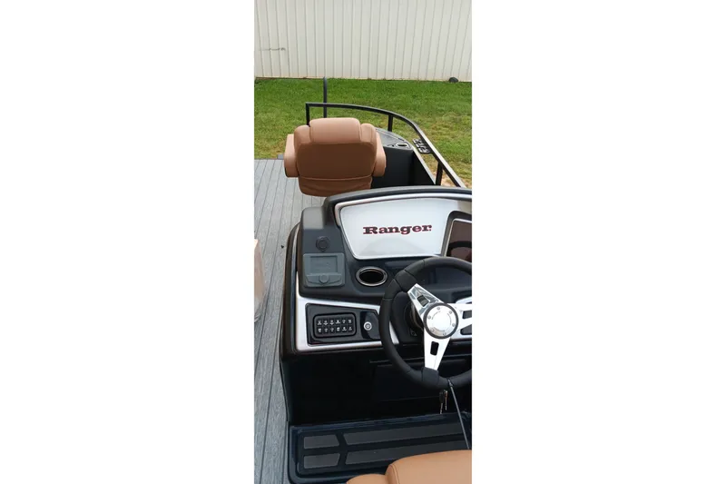 Slide: The Image of 2026 Ranger 220F boat dashboard with steering wheel and control panel. - 16